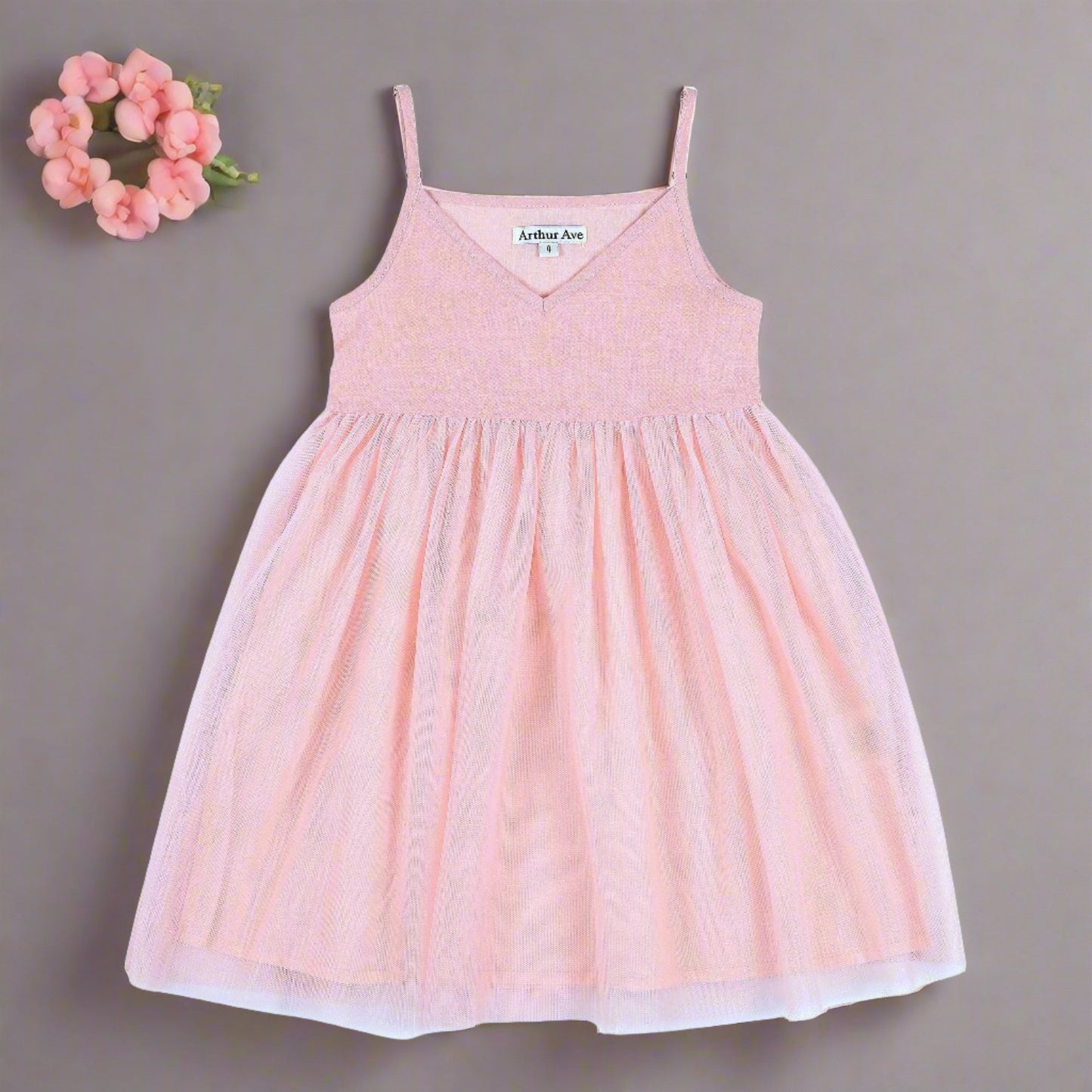 From the London Pink Collection by Arthur Ave the Tulle Babydoll Dress is the ultimate dress for the summer. A vee neck slip on dress with adjustable straps. If your little girl loves to dance, spin &amp; twirl this is will be one of her favorites this summer whatever the occasion. Made from hemp, viscose &amp; cotton, perfect for those hot days!